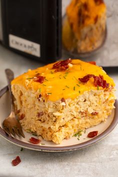 a piece of rice casserole on a plate next to an instant pressure cooker