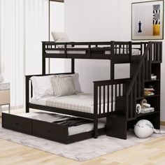 a bunk bed with a trundle underneath it in a room that has hardwood floors and white walls