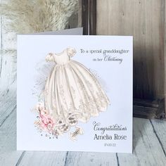 a greeting card with an image of a white dress and pink flowers on the front