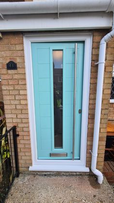 a blue front door on a brick building