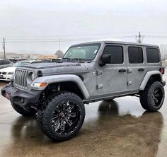 a gray jeep parked in a parking lot