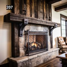 a fireplace in a living room with wood paneling on the walls and an open fire place