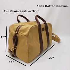 Beautiful, Rugged Harvest Tan 18oz Cotton Canvas Travel Bag with commercial water repellent finish and Full Grain Leather Handles and Trim. It's comfortable in the hand or over the shoulder. Will carry your things in style. Durability that will last.Size:20" wide x 13" height x 11" depth2" Wide adjustable shoulder strapMaterials:18oz Durable Cotton Canvas with commercial water repellent finish and Full Grain Leather TrimMade in the U.S.A.PROCESSING TIME:Your item will ship within 1-5 business da Classic Rectangular Coated Canvas Box Bag, Brown Coated Canvas Box Bag For Daily Use, Classic Coated Canvas Box Bag For Daily Use, Travel Box Bag In Brown Coated Canvas, Brown Coated Canvas Box Bag For Travel, Large Capacity Coated Canvas Bag With Double Handle, Brown Coated Canvas Box Bag For Everyday Use, Daily Use Coated Canvas Satchel Box Bag, Coated Canvas Satchel Box Bag For Daily Use