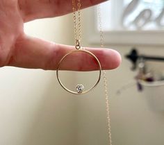 "Open circle necklace with floating diamond Necklace Dainty and Beautiful Perfect for layering or alone. A symbol of never ending love, our modern open circle necklace is elevated by a tiny floating diamond CZ, set inside. To purchase the sterling silver click on the link below https://www.etsy.com/listing/1362593945/gold-filled-circle-necklace-with?click_key=bed2caf44a19067a29a803b0a5bba4d223c6d443%3A1362593945&click_sum=b684c8c0&ref=shop_home_active_1&frs=1&sts=1 -Details Charm - 14kt gold fil Modern Necklace With Round Cut For Gift, Minimalist Halo Necklace, Modern Round Cut Necklace For Gift, Minimalist Halo Necklace For Gift, Minimalist Halo Necklace As Gift, Minimalist Halo Necklace For Gifts, Minimalist Halo Round Pendant Jewelry, Modern Open Circle Necklaces For Anniversary, Modern Open Circle Necklace For Anniversary