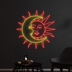 a neon sun and moon wall sticker in a dark room with a black chair