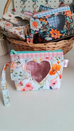 a basket filled with lots of different types of purses next to each other on top of a table