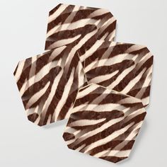 four zebra print coasters sitting on top of each other