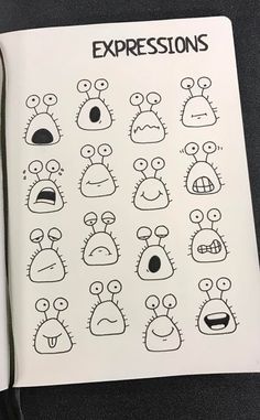 an open notebook with drawings of different expressions on the pages, including eyes and mouths