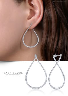 These pear shaped diamond hoop earrings are a fresh take on a timeless style. Set with 1.40cts of brilliant round pavé diamonds, these unique front facing hoops curve gently from the front to the back of the ear. These 14k white gold hoop earrings exude a refined elegance. EG12903W45JJ #GabrielNY #DiamondJewelry #FineJewelry #GabrielAndCo #UniqueJewelry #FineJewelry#FashionJewelry #DiamondJewelry #Jewelry #Earrings #FashionEarrings White Gold Hoop Earrings, Geode Jewelry, White Gold Hoops, Bridal Gold Jewellery, Diamond Hoop Earrings, Pear Shaped Diamond, Girly Jewelry, Fine Jewellery Earrings, Fine Jewellery