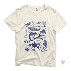 Dive into the timeless beauty of the ocean with our vintage sea life illustration t-shirt. Perfectly capturing the spirit of the sea, this shirt features intricate, classic artwork of various marine creatures that will transport you to a serene underwater world. Made from soft, high-quality cotton, this tee is designed for comfort and durability, making it ideal for everyday wear. Whether you're a beach lover, a marine enthusiast, or someone who appreciates vintage art, this shirt is a perfect a Aesthetic T Shirts Vintage, Ocean Clothes, T Shirt Design Ideas Ocean, Ocean Shirts, Sea Life Illustration, Whale Shirt Aesthetic, Sea World Shirts, Jellyfish Shirt, Ocean Tshirt