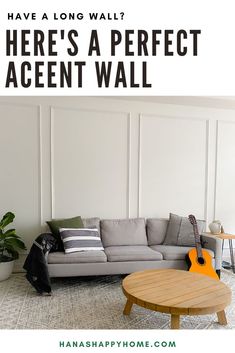 a living room with a couch and guitar on the floor, text overlay reads have a long wall? here's a perfect accent wall