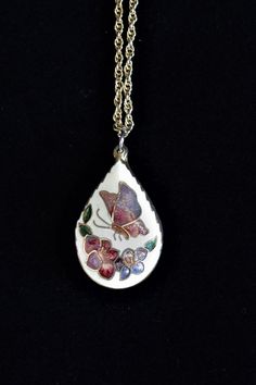 "Welcome to TarasVintageShoppe. For the lover of Timeless Treasures! You are looking at a vintage, Cloisonné, enamel necklace. Including the charm, the necklace hangs 10 1/2\" long. Teardrop in shape, it has a lovely butterfly and flower design. The chain is costume gold, and the entire piece is in well kept, vintage condition! DIMENSIONS: Charm is 1 1/8\" long the necklace with the charm is 10 1/2\" long. Any questions? Please don't hesitate to ask. Any reasonable offer on vintage items will be Vintage Enamel Jewelry With Vintage Charm, Vintage Enamel Jewelry For Collectors, Vintage Enamel Collectible Jewelry, Retro Enamel Necklaces For Gift, Vintage Enamel Necklace With Large Pendant, Vintage Enamel Necklaces With Lobster Clasp, Enamel Pendant Necklaces With Vintage Charm, Vintage Nickel-free Necklace With Flower Pendant, Vintage Enamel Flower Pendant Jewelry