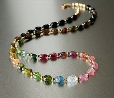 Adding a vibrant dash to any look, the cool, dainty multicoloured tourmaline stones combined with 14-karat gold-filled findings are beautiful and provide a feminine allure to your apparel. Make your collection and combine this piece with gold beaded necklaces for a sophisticated outfit! A perfect gift to spoil yourself or a loved one! Kindly refrain from assuming the size of the beads; instead, kindly refer to the dimensions provided in the description. 💜 G E M S T O N E S 💜 * Gemstone: Natura Luxury Tourmaline Necklace With Faceted Beads, Month October, Raw Tourmaline, Bracelets Patterns, Nugget Necklace, 8th Anniversary, Diy Bracelets Patterns, Gold Bead Necklace, Tourmaline Jewelry