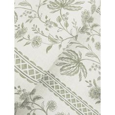 a white and green floral print fabric with an intricate design on the bottom half of it