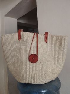 "White sisal tote bag with long shoulder length straps  DIMENSIONS Bottom width: 10\"/25.5cm Top width: 14\"/35.56cm Depth: 10\"/25.5cm Straps: 15\"/38cm SHIPPING All orders ship via DHL Express (3-5) days delivery time." White Handwoven Straw Shoulder Bag, Natural Basket-shaped Shoulder Bag, White Woven Crochet Basket Bag, White Crochet Basket Bag For Shopping, Natural Basket Shape Shoulder Bag, White Tote Bag In Natural Fiber, White Woven Basket Shoulder Bag, White Handwoven Straw Bag For Market, Beige Basket Shoulder Bag With Rolled Handles