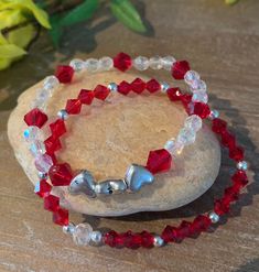 Red crystal bead bracelet set of 2. This handmade, stretch bracelet has heart spacers that make it a great addition to your collection. These bracelet is just gorgeous and perfect gift for that someone special. Wear this alone or stack with others. Nothing says love better than this bracelet. Price is for the set Visit my Etsy shop at   Etsy.me/4aWMaHB CARE: Roll bracelet on and off Do not expose to water, sunlight, or lotions Remove at night Adjustable Heart-shaped Crystal Bracelet, Crystal Heart Bracelets For Valentine's Day, Heart-shaped Crystal Bracelets For Valentine's Day, Silver Beaded Crystal Bracelet For Valentine's Day, Valentine's Day Silver Beaded Crystal Bracelet, Valentine's Day Adjustable Crystal Bracelet, Heart-shaped Bracelets With Faceted Beads For Gifts, Heart Shaped Bracelets With Faceted Beads For Gifts, Heart-shaped Bracelet With Faceted Beads For Gifts