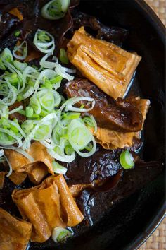 some food is in a black bowl on a table