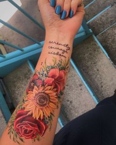 a woman's arm with sunflowers and roses on it