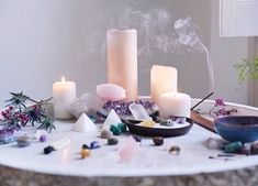 a table topped with candles and rocks on top of it