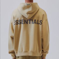 No Offers & No Trades On This Item The Fog Essentials Pullover Hoodie Features A Roomy Fit, A Matching Hood, Long Sleeves With Dropped Shoulders, And A Reflective Brand Graphic At The Back. Solid Twill Pullover Hoodie Reflective Fog Essentials Back Graphic Embroidered Logo On Sleeve Cuff Kangaroo Pocket Long Sleeves Dropped Shoulders Oversized Fit 80% Cotton, 20% Polyester Model Is Wearing Size Medium Beige Hoodie For Streetwear Athleisure, Beige Hoodie For Streetwear In Athleisure Style, Beige Athleisure Hoodie For Streetwear, Essential Long Sleeve Hoodie For Streetwear, Essential Fall Hoodie Sweatshirt, Essential Hoodie Sweatshirt For Streetwear, Essential Streetwear Hoodie Sweatshirt, Essential Long Sleeve Winter Sweatshirt, Winter Long Sleeve Sweatshirt