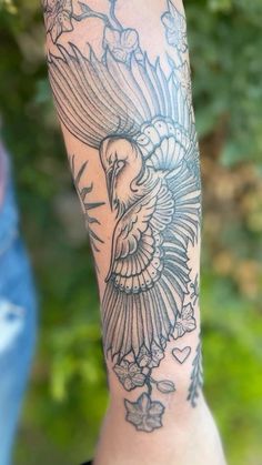 a person with a bird tattoo on their arm