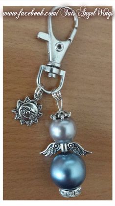 a key chain with two charms attached to it