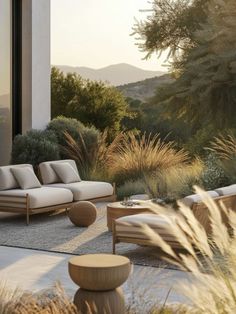 an outdoor living area with couches and tables