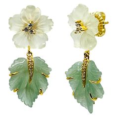 Bijoux Num's Hand Carved Serpentine Flower and Aventurine Leaf Drop Earrings This gorgeous pair of earrings features beautiful pair of hand-carved 15mm pale-green serpentine flower and 18mm green aventurine leaf adorned with round simulated diamonds, handset in 18k yellow gold vermeil over sterling silver. Straight post with large friction earring back. The post is set in the middle of the top stone setting allowing the earrings to sit beautifully on the ear. The earrings measured 1-1/4" height Druzy Quartz, Stone Setting, Blue Quartz, Diamond Drops, Modern Earrings, Diamond Drop Earrings, Green Aventurine, Pale Green, Gold Flowers