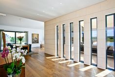 an empty room with wooden floors and sliding glass doors