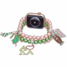 Alpha Kappa Alpha Sorority Paraphernalia Women's Watch Band. Silver Metal with 3 Rows of Pink and Green Acrylic Pearl Stretch Strands Featuring 5 Different Rhinestone Pink and Green AKA Sorority Charms. Fits 38. 40. 41 mm. Easy Adjustable Sizing. Band measures 1" wide. Pretty Girl Plate Charm measures 1.25". Alpha Kappa Alpha Jackets, Greek Sorority Paddles, Aka Apparel, Sorority Paraphernalia, Aka Alpha Kappa Alpha, Alpha Kappa Alpha Sorority Paraphernalia, Sorority Row, Aka Sorority Gifts, Greek Paraphernalia