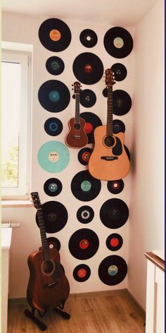 a room with guitars and records on the wall