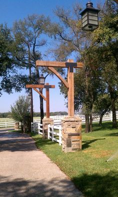 a wooden structure sitting on top of a lush green field