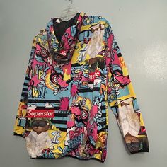 This Windbreaker Is Brand New. It Was Never Worn. The Details Are In The Pics. The Measurements Are In The Pics. Multicolored Trendy Multicolor Hooded Windbreaker, Trendy Multicolor Long Sleeve Windbreaker, Multicolor Hooded Outerwear With Graphic Print, Multicolor Graphic Print Hooded Outerwear, Urban Multicolor Windbreaker For Spring, Multicolor Urban Windbreaker For Spring, Urban Style Multicolor Spring Windbreaker, Urban Multicolor Spring Windbreaker, Urban Multicolor Outerwear With Graphic Print