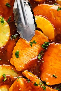 oranges and lemons are being cooked in a sauce