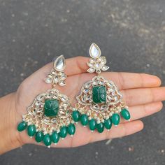 The Emerald Krishanya Earrings are unique, and lightweight chandbalis with Kundan and Gold-Plating on beautiful beaded crystals. Specifications Materials used: Kundan, beaded crystals, Gold Plating Weight: 19 g Height: 3.5 inches At Romikas, we pride ourselves on the craftsmanship and high quality of our jewelry, designed to enhance your natural beauty. Please contact us with any questions. Temple Jewelry Beaded Earrings For Parties, Temple Jewelry Chandbali Beaded Earrings, Party Chandbali Beaded Danglers, Beaded Chandbali Earrings For Celebration, Celebration Chandbali Beaded Earrings, Celebration Beaded Chandbali Earrings, Celebration Chandbalis With Dangling Beads, Silver Jeweled Chandbali Chandelier Earrings, Jeweled Chandbali Chandelier Earrings For Celebration