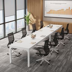 an empty conference table with black chairs in front of a large poster on the wall