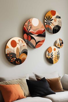 three decorative plates mounted on the wall above a couch