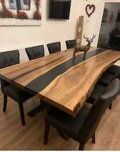 a dining room table made out of wood and black leather upholstered with antlers