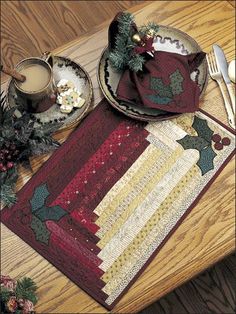 a placemat, napkins and two cups on a wooden table with silverware