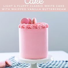 a pink cake sitting on top of a table