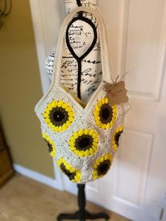 This fun, sunflower crocheted  boho tote is handmade with a creamy base color with bright sunflowers complimented with a bright yellow fabric liner inside Yellow Crochet Tote Bag For Vacation, Yellow Crochet Tote Bag For Summer, Yellow Crochet Tote Bag For Spring, Yellow Crochet Bag For Spring, Spring Yellow Crochet Bag, Handmade Yellow Beach Bag For Summer, Yellow Bohemian Tote Beach Bag, Yellow Bohemian Beach Bag Tote, Yellow Bohemian Crochet Beach Bag