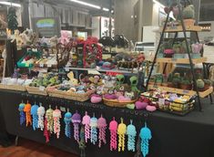 an assortment of stuffed animals and other items on display at a vendor's booth