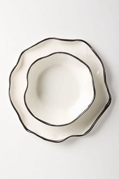 two black and white plates sitting on top of each other