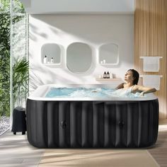 an inflatable hot tub sits on the floor next to a large mirror and potted plant