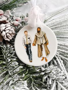 a christmas ornament with two people on it