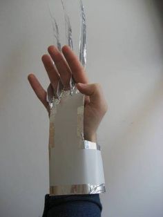 a person holding up their hand with plastic wrap around it