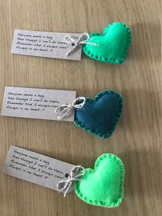 three felt hearts with tags attached to them