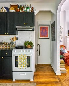 a white stove top oven sitting inside of a kitchen