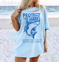 Protect The Sharks Tshirt, Respect The Locals Shark Shirt, Beach Lover Tee, Shark Lover Gift, Marine Life Shirt. The soft-washed, garment-dyed fabric brings an extra coziness to your wardrobe, while the relaxed fit makes it an excellent daily choice. The double-needle stitching throughout the tee makes it highly durable while the lack of side seams helps the shirt retain its tubular shape. - Comfort Colors garment-dyed t-shirt  - A fully customizable tee made 100% with ring-spun cotton. - 100% r Shark Shirt Aesthetic, Shark Clothes, Whale Shark Shirt, Summer Short Sleeve T-shirt With Shark Design, Casual Short Sleeve T-shirt With Shark Design, Shark Tee, Summer T-shirt With Shark Design, Short Sleeve, Vacation Tshirts, Whale Shirt