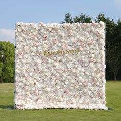 a large white and pink flower covered wall